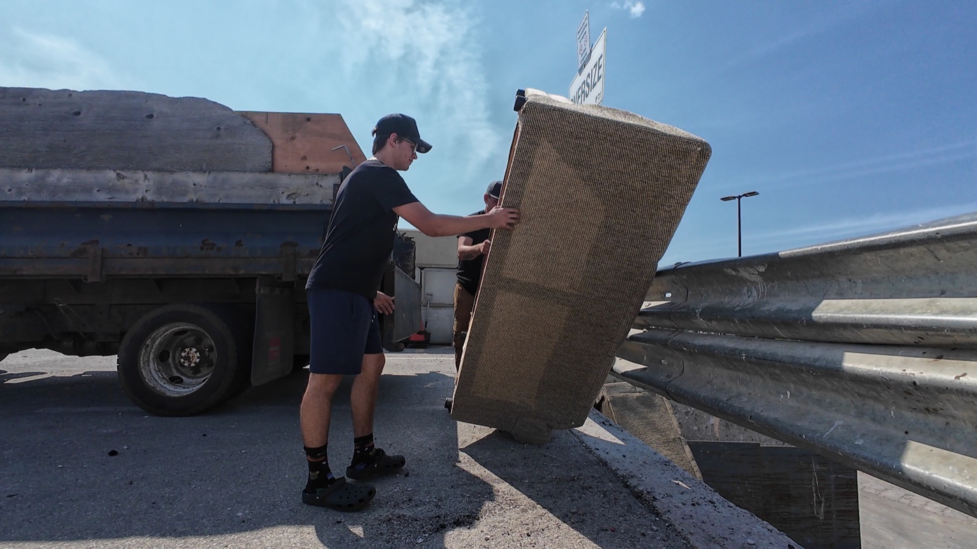 Junk Bandits crew loading a couch during a real Mississauga junk removal job